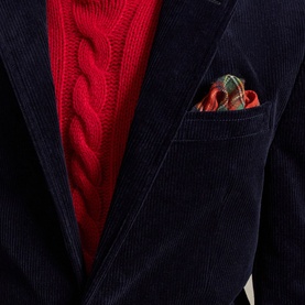 Navy corduroy blazer styled with a red cable-knit jumper and red paisley pocket square