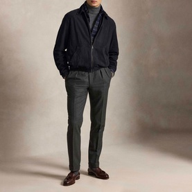 Model wearing Ralph Lauren Collection Navy casual zip-up jacket, styled with grey turtleneck, dark trousers and brown leather loafers.