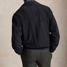 Model wearing Ralph Lauren Collection Navy casual jacket, rear view, styled with grey trousers and plaid collar detail visible.