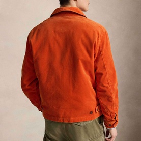 Model wearing Ralph Lauren college orange corduroy casual jacket, rear view, styled with olive green trousers.