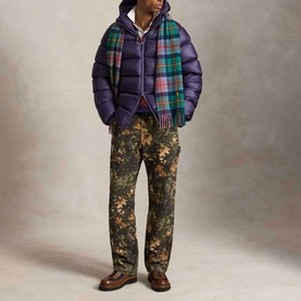 Model wearing Ralph Lauren Junberry casual puffer jacket with plaid scarf, floral camo trousers and brown boots
