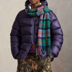 Model wearing Ralph Lauren Junberry puffer casual jacket, styled with a green tartan scarf and floral trousers.