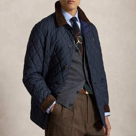 Model wearing Ralph Lauren navy quilted casual jacket with brown corduroy collar, styled with grey waistcoat and checked trousers