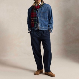 Model wearing Ralph Lauren Aviator Navy chino trousers, styled with a denim jacket, plaid scarf and tan loafers.