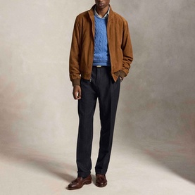 Model wearing Ralph Lauren Turquoise Jay Heather crew neck knit, styled with tan suede bomber jacket and navy trousers.
