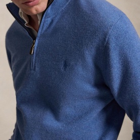 Model wearing a blue marl half-zip knit jumper with small embroidered pony logo, styled with a collared shirt underneath