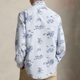 Model wearing Ralph Lauren Dog & Pheasant Logo Striped Oxford Shirt in white with navy scenic print, long sleeves, back yoke detail visible.