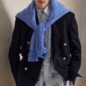 Model wearing Ralph Lauren Dog & Pheasant Logo Striped Oxford Shirt in scenic print, styled with navy double-breasted blazer and blue cable-knit
