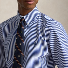 Model wearing Ralph Lauren Polo Player Logo Striped Shirt in Rugby Royal White with navy stripe, paired with a patterned tie.