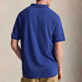 Model wearing Ralph Lauren Pony Logo Slim Fit Mesh Polo Shirt in Blue Yacht, rear view, ribbed collar and short sleeves visible.