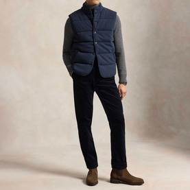 Model wearing Ralph Lauren winter navy heather dogtooth sweat, styled with navy quilted gilet, navy trousers and brown suede Chelsea boots.