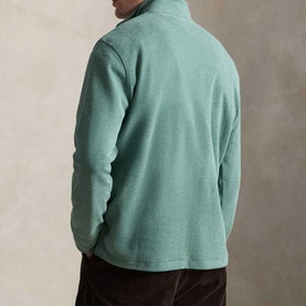 Model wearing Ralph Lauren pine heather sweatshirt, back view, styled with dark brown corduroy trousers