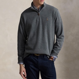 Model wearing Ralph Lauren Barclay Heather quarter-zip sweatshirt, styled with a checked shirt and dark jeans.