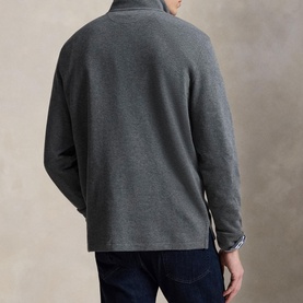 Model wearing Ralph Lauren Barclay Heather sweatshirt, back view, styled with dark navy jeans and checked shirt collar visible.