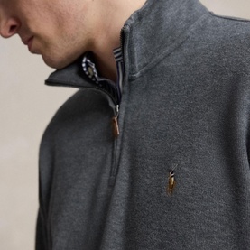 Model wearing Ralph Lauren Barclay Heather quarter-zip sweatshirt, close-up showing gold-tone zipper pull and embroidered pony logo