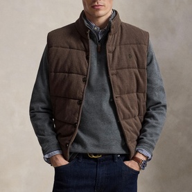 Model wearing Ralph Lauren Barclay Heather sweatshirt, styled with a brown quilted gilet and navy jeans.