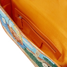 Staud Sunset Spritz beaded shoulder bag interior showing orange suede lining and silver zip pocket detail