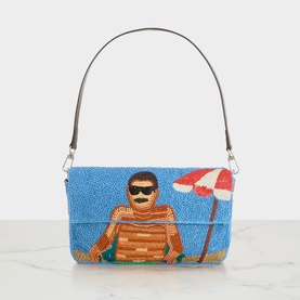 Staud Timmy Sundaze Beaded Shoulder Bag in blue with beachgoer and umbrella motif, flap fastening, silver-tone hardware, detachable strap