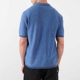 Model wearing Wax London Ivy Washed Shirt in blue, rear view showing dropped shoulders, short sleeves, and textured stitch detailing