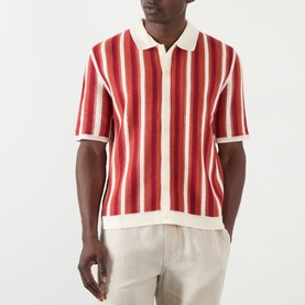Model wearing Wax London Porto Striped Cardigan in ecru and orange, short sleeves, polo collar, button front, styled with cream trousers