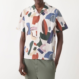 Model wearing Wax London Didcot Abstract Print Shirt in ecru/multi with camp collar, styled with olive green trousers