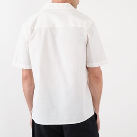 Model wearing Wax London Didcot Floral Shirt in ecru, rear view showing dropped shoulders and short sleeves with straight hem.