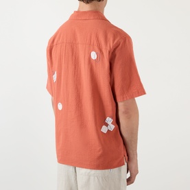 Model wearing Wax London Didcot Scribble Casual Shirt in terracotta, short sleeves, relaxed fit, white squiggle applique detail, back view.