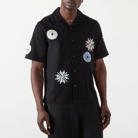 Model wearing Wax London Ditcot Embellished Bowling Shirt in black with multi-colour snowflake appliqu&eacute;s, notched collar, short sleeves.