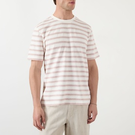 Model wearing Wax London Dean Stitched Striped T-Shirt in ecru and rust horizontal stripes, crew neck, short sleeves, paired with light trousers.