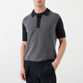 Model wearing Wax London Turin Knitted Polo Shirt in navy, featuring ribbed texture, contrast panels, buttoned placket and short sleeves