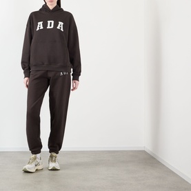 Model wearing Adanola ADA Logo Oversized Hoodie in Coffee Bean with matching joggers and chunky trainers