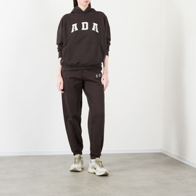 Model wearing Adanola ADA Logo Oversized Hoodie in Coffee Bean with matching dark joggers and chunky trainers.