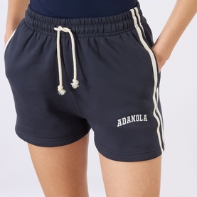 Model wearing Adanola Shorts in Midnight Blue with Marshmellow White contrast side stripes and drawstring waistband.