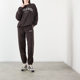 Model wearing Adanola AS Logo Oversized Sweatshirt in Coffee Bean, styled with matching joggers and white trainers