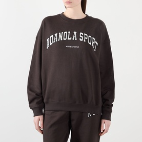 Model wearing Adanola AS Logo Oversized Sweatshirt in Coffee Bean, crew neck with white varsity logo print, styled with matching sweatpants