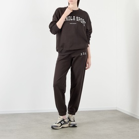 Model wearing Adanola AS Logo Oversized Sweatshirt in Coffee Bean with matching joggers and chunky trainers