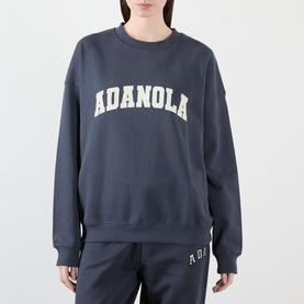Model wearing Adanola Varsity Logo Oversized Sweatshirt in Midnight Blue with matching joggers, crew neck, dropped shoulders, varsity logo front.