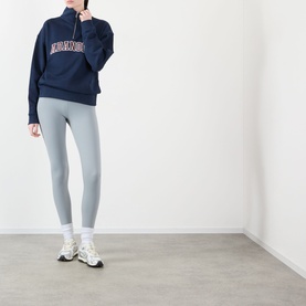 Model wearing Adanola Varsity Logo Half-Zip Sweatshirt in Navy Blue/Burgundy with light blue leggings and white trainers.