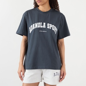 Model wearing Adanola ADA Sport Oversized Logo T-Shirt in Midnight Blue with white varsity lettering, styled with light grey shorts.