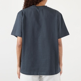 Model wearing Adanola ADA Sport Oversized Logo T-Shirt in Midnight Blue, rear view showing dropped shoulders and straight hem.