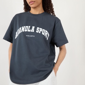 Model wearing Adanola ADA Sport Oversized Logo T-Shirt in Midnight Blue with white varsity-style logo print, crew neck, short sleeves.