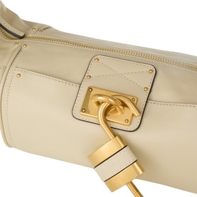 Chloe Cloudy Cream buffalo leather shoulder bag, close-up of gold-tone padlock clasp and quilted front pocket detail