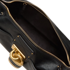 Chlo&eacute; Paddington Hobo Shoulder Bag in black leather, interior view showing gold-tone zip, padlock charm detail and studded base.