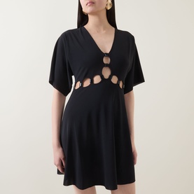 Model wearing Eres Connection Cut-Out Beach Dress in Noir, featuring V-neckline, cut-out detailing, flutter sleeves and flared mini skirt