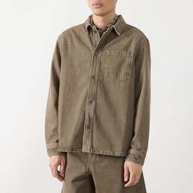 Model wearing Les Deux Chest Pocket Denim Overshirt in light brown denim wash, with button fastening and chest pocket, styled with matching trousers.