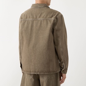 Model wearing Les Deux Chest Pocket Denim Overshirt in light brown denim wash, back view, styled with matching trousers