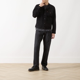 Model wearing Levi's black cotton casual jacket styled with dark jeans and black shoes.