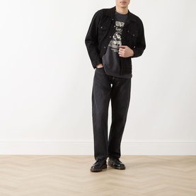 Model wearing Levi's Berk Night black cotton casual jacket, styled with matching dark jeans and black loafers