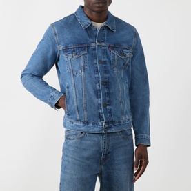 Model wearing Levi's washed blue denim casual jacket with chest pockets and button front, styled with matching blue denim jeans