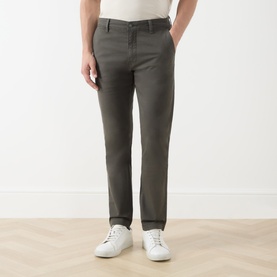 Model wearing Levis XX Mid-Rise Chino in Komodo Shady green-grey, styled with white low-top trainers and a light tucked top.